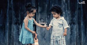 children passing dandilion flowers to each other