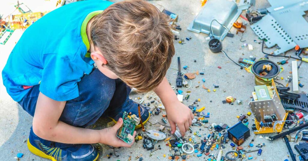Child building with spare electronic parts
