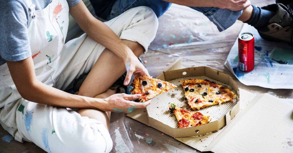 Couple renovating house with pizza box