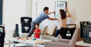 Family hanging up pictures after moving in.