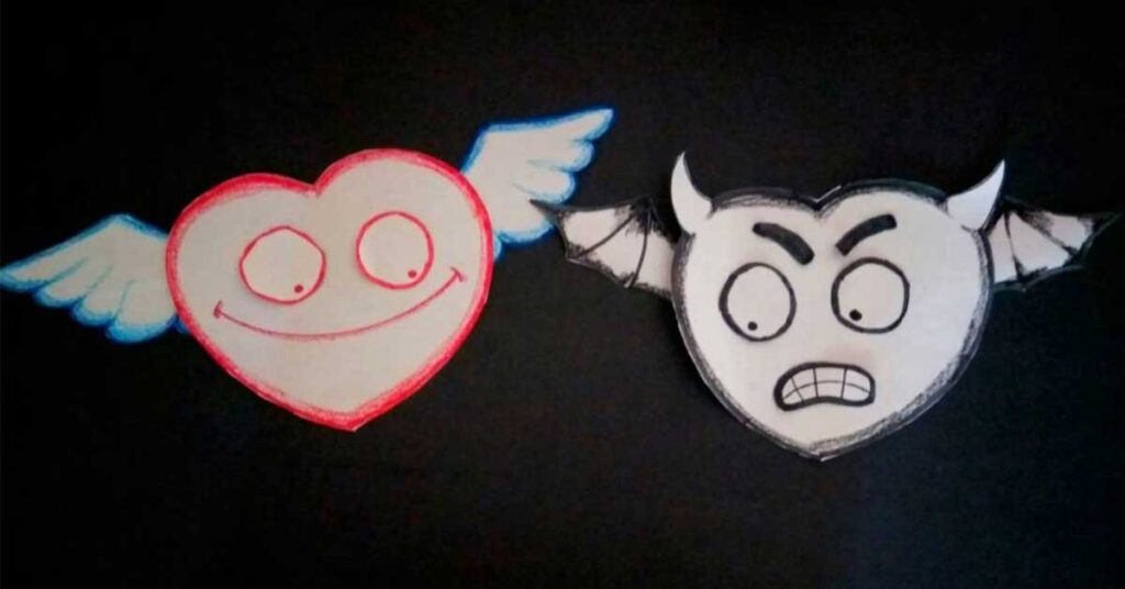 Papercraft of 2 hearts with wings and one is a devil face and one has an angel face