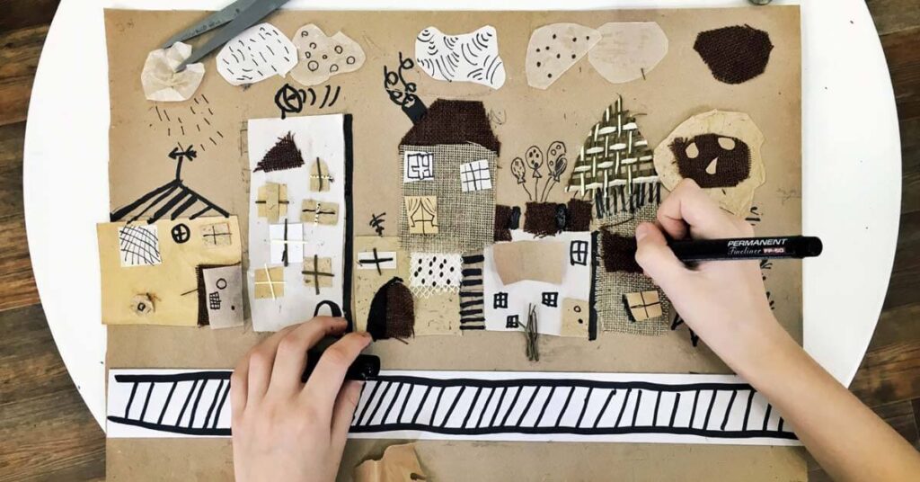 Scrapbook picture of a town made with paper and black marker