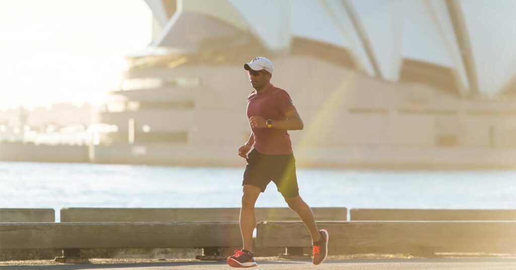 Man running in from of the Sydney Opera House