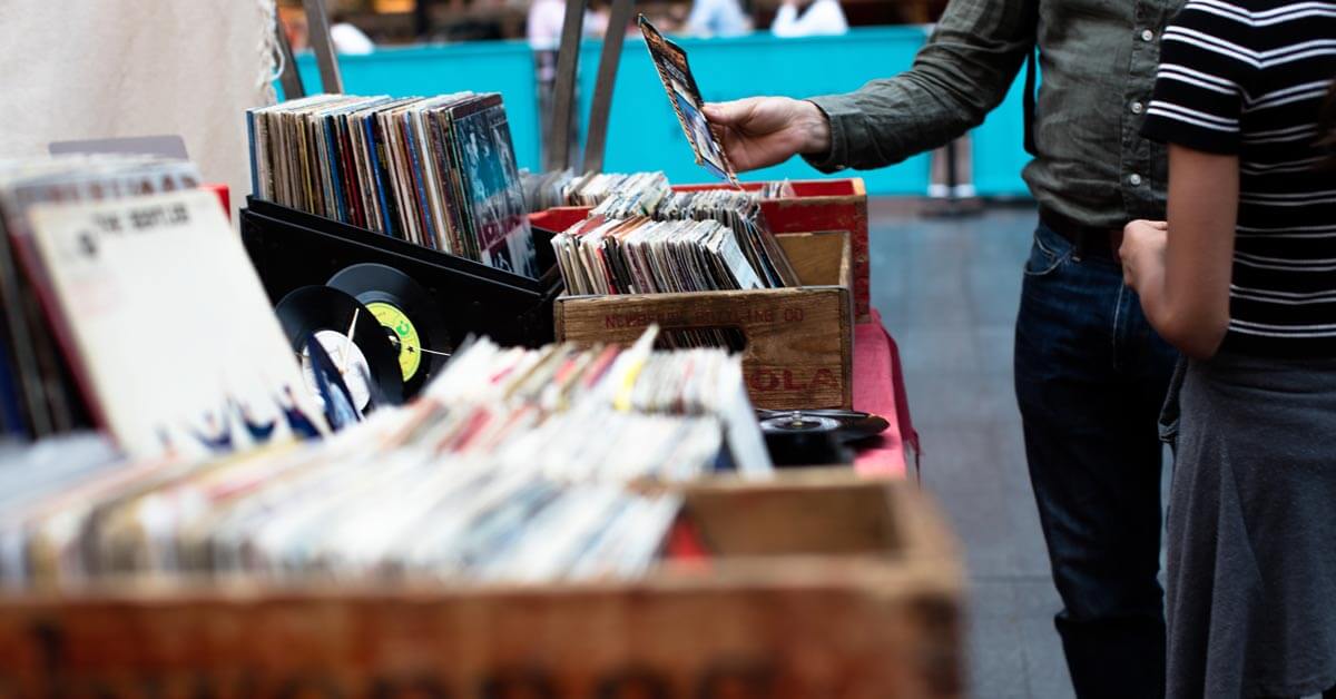 Vinyl records sitting in wooden bins on display for shoppers